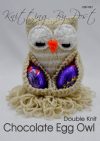 A hand-knitted chocolate egg owl made from soft brown yarn, with white and orange accents for the eyes and beak. The owl features a cozy pocket designed to hold a standard-sized chocolate egg, making it a perfect handmade gift for Easter or special occasions.