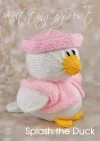 Splash the Duck knitting pattern. Easter-themed knitted toy duck approximately 16cm tall, featuring a white body, pink hat, and matching scarf.