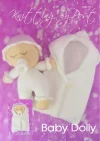 Baby Dolly knitting pattern. White knitted toy doll approximately 19cm long, featuring a round head, stitched facial features, and accompanied by a matching sleeping bag.