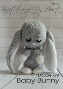 Baby Bunny knitting pattern. Grey-colored knitted toy rabbit approximately 15cm tall, featuring a soft, cuddly design, perfect for Easter gifts, nurseries, or baby showers.