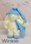 Winkie the Bunny knitting pattern. Cream-colored knitted toy rabbit approximately 23cm tall, featuring a blue sleeping cap, matching blanket, and removable slippers.