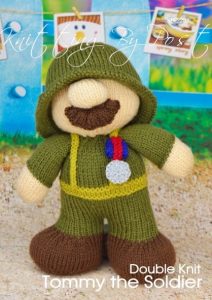 Tommy the Soldier knitting pattern. World War I-themed knitted toy soldier approximately 22cm tall, featuring a dark green uniform, tin hat, and service medal.