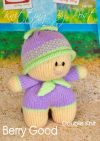 Berry Good Dolly knitting pattern. Cream-colored knitted toy doll approximately 16cm tall, featuring a lilac dress, green accents, and a berry-themed hat, perfect for fruit lovers and fun playtime.