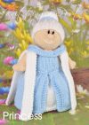 Princess knitting pattern. Cream-colored knitted toy doll approximately 32cm tall, featuring a blue ball gown and white accessories, embodying a royal princess theme