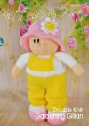 Gillian Gardening Girl knitting pattern. Cream-colored knitted toy doll approximately 32cm tall, dressed in yellow dungarees and a pink hat, embodying a gardening theme.