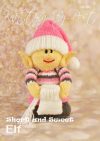 Short and Sweet Elf toy knitting pattern. Knitted elf wearing a pink outfit with grey and white accents, approximately 22cm tall.