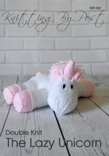 The Lazy Unicorn knitting pattern – white and pink knitted unicorn soft toy lying down, approximately 30cm long, knitted with double knitting yarn.