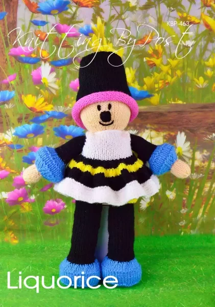 Liquorice Dolly knitting pattern. Cream-colored knitted toy doll approximately 34cm tall, featuring black, blue, white, pink, and yellow accents, inspired by the sweet treat.