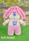 Ruth the Rabbit knitting pattern. Cream-colored knitted toy rabbit approximately 26cm tall, featuring a pink dress and lilac accents.
