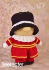 Beefeater toy knitting pattern. Knitted figure representing a Beefeater guard, wearing a red tunic, black hat, and white ruff, approximately 25cm tall