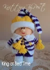 King at Bed Time toy knitting pattern. Knitted figure representing a king in purple pyjamas and yellow crown, approximately 25cm tall.