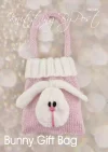 Bunny Rabbit Gift Bag knitting pattern. Easter-themed knitted bag approximately 15cm tall and 12cm wide, featuring a pink body with a white bunny face and ears, perfect for holding small treats or gifts.