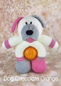 Chocolate Orange Dog knitting pattern. Cream-colored knitted toy dog approximately 26cm tall, featuring a pink nose, grey ears, and a hollow body designed to hold a chocolate orange.