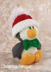 Christmas Penguin knitting pattern. Christmas-themed knitted toy penguin approximately 23cm tall, featuring a grey and white body with red accents.