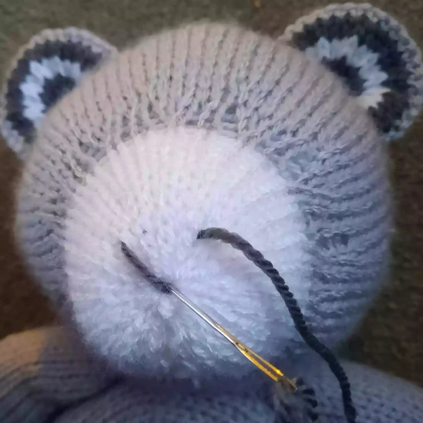 How to sew a nose to a knitted toy - step 4