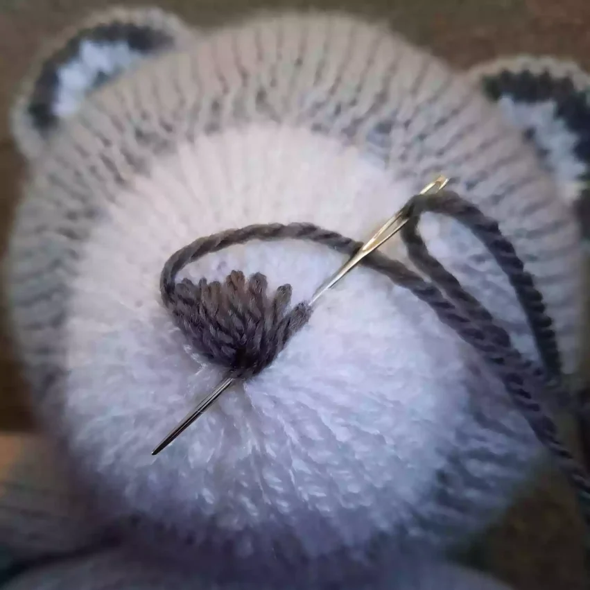 How to sew a nose to a knitted toy - step 7