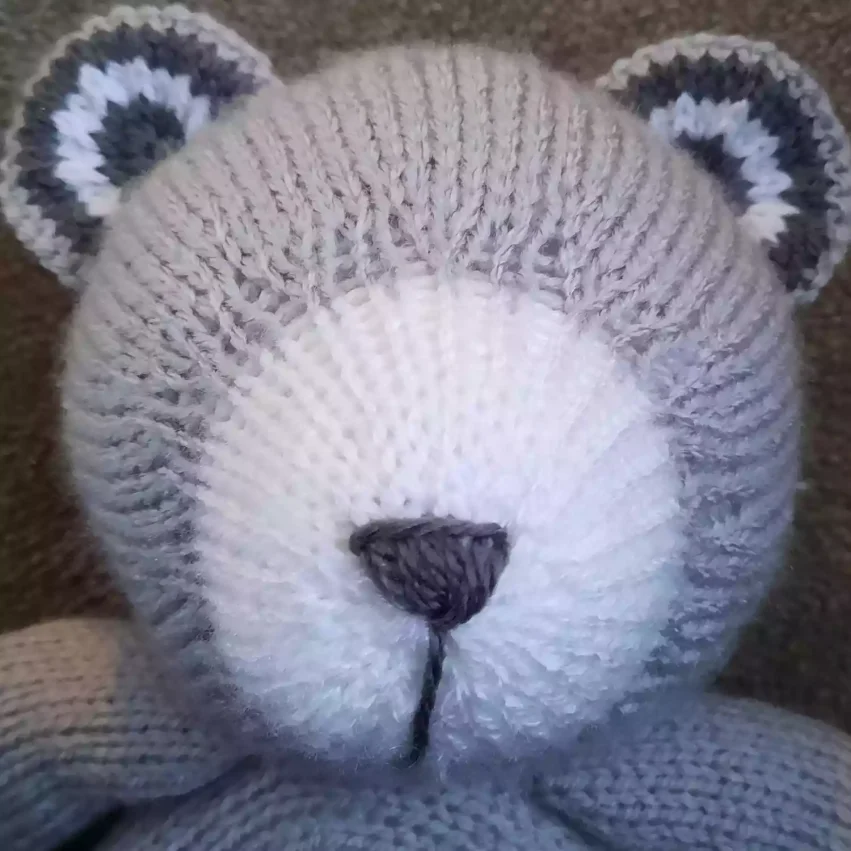 How to sew a nose to a knitted toy - step 8