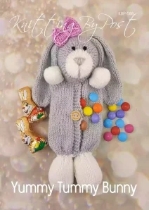 An Easter bunny knitting pattern with a grey body, white paws, and a pink bow on its head. The bunny has a button on its belly and colorful candy-coated chocolates spilling from an opening in its front.