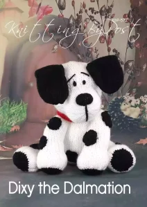 Dixy the Dalmatian knitting pattern. White knitted toy dog approximately 24cm tall in a seated position, featuring black spots, floppy ears, and a red collar.