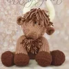 a brown highland cow soft toy with dark brown feet cream horns and tufts on head and chest made from the glen-coo highland cow knitting pattern