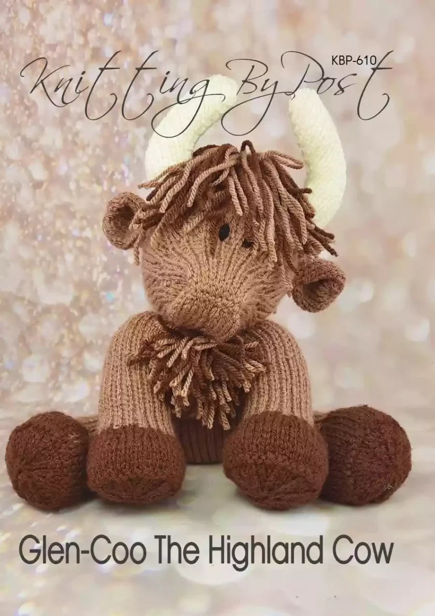 a brown highland cow soft toy with dark brown feet cream horns and tufts on head and chest made from the glen-coo highland cow knitting pattern